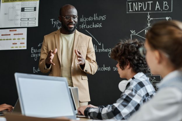 Teacher explaining the work of computer system